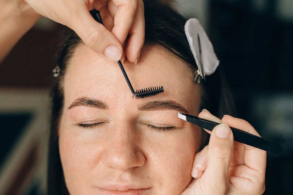Brow shaping treatment in progress, close up