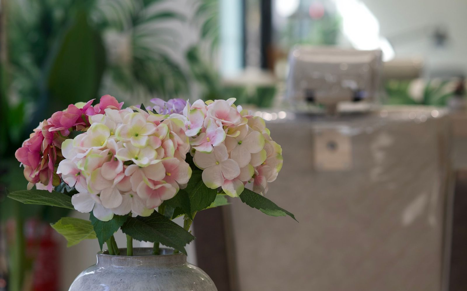 Salon reception desk with fresh flowers and warm light