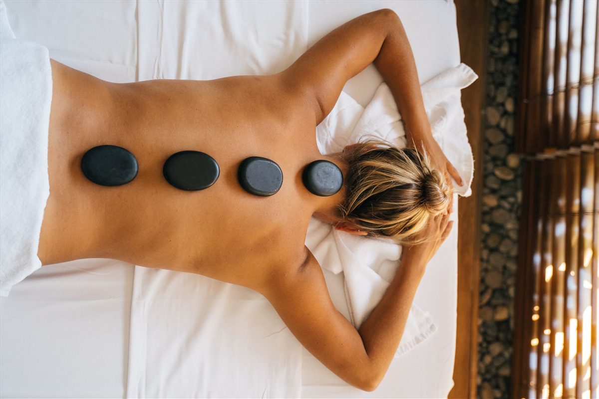 Hot stone massage being carried out on a client's back